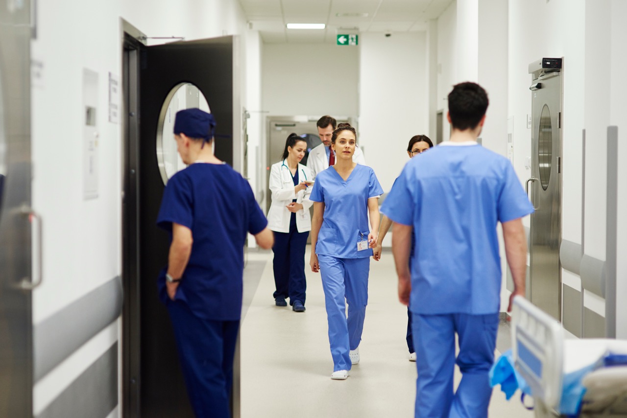 doctors walking through corridor in hospital
