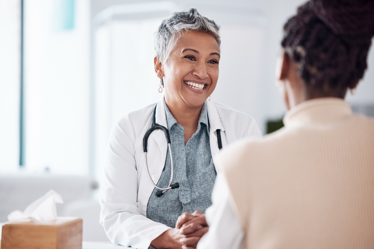 happy, mature or doctor consulting a patient in meeting in hospital for healthcare help, feedback or support. people, medical or nurse with black woman talking or speaking of test results or advice